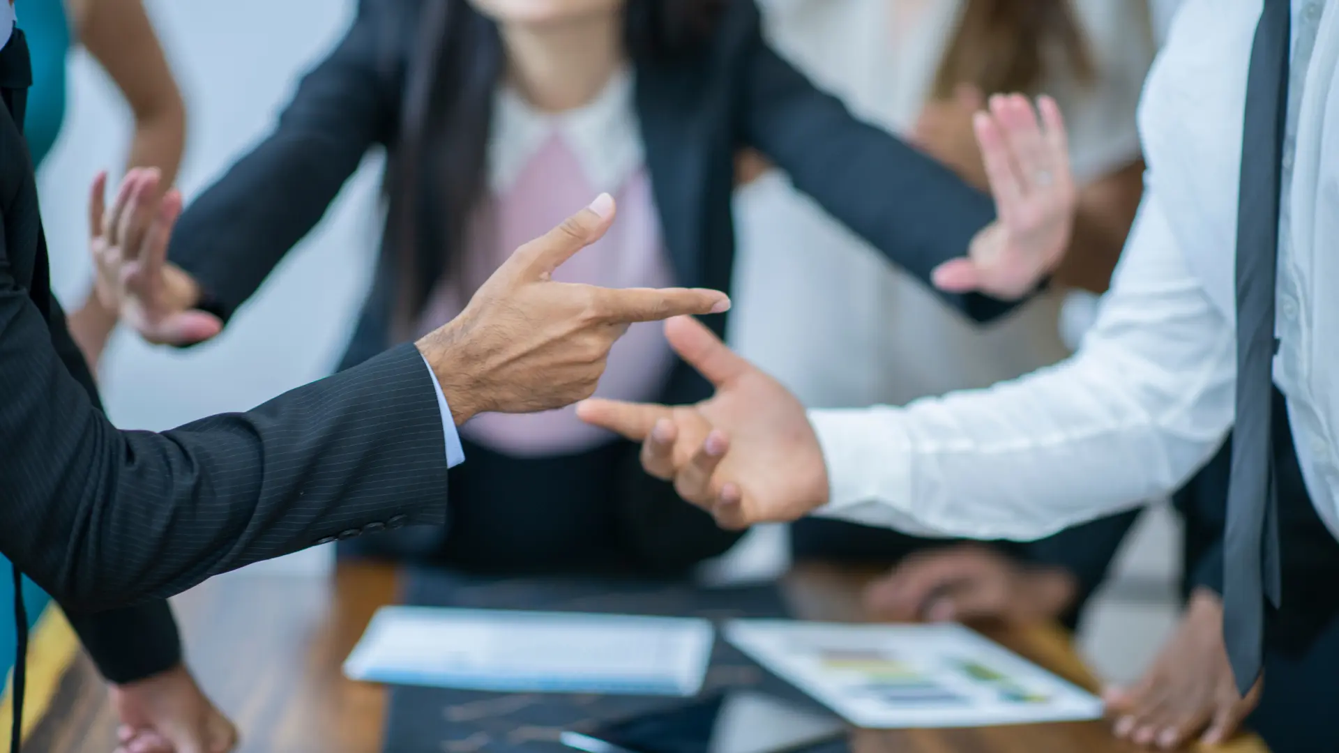 Hands of people in a heated discussion or negotiation in a business meeting.