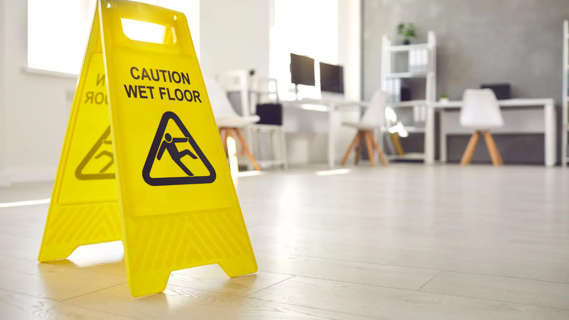 Yellow caution wet floor sign in an office setting.